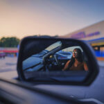 A Girl In A Car In A Parking Lot